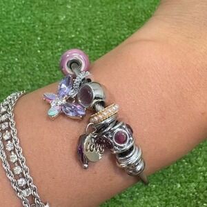 Silver color cable bracelet with‎ purple butterfly accents